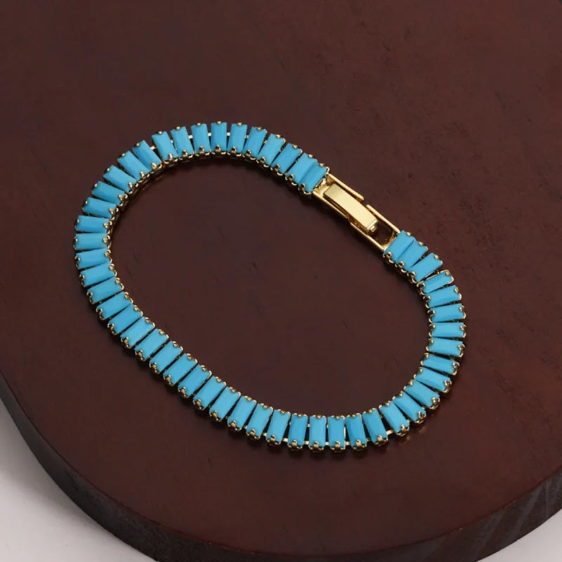 Bracelets rivières dorés et argentés sertis de pierres turquoise synthétiques : formes rectangulaires.