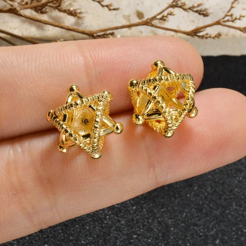 Boucles d'oreilles puces dorées en forme de sphères entrelacées texturées, design géométrique et style vintage.