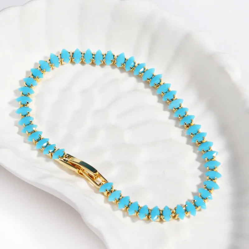 Bracelets rivières dorés et argentés sertis de pierres turquoise synthétiques : formes ovale